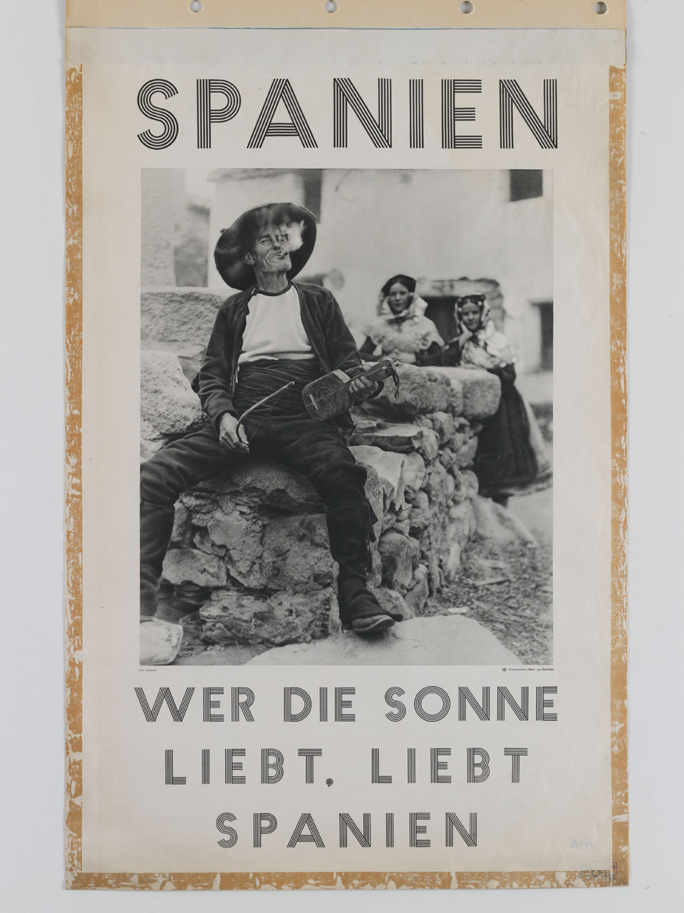 vecchio con monocordo in mano fuma il sigaro seduto sopra muretto mentre due ragazze in abiti tradizionali lo osservano (manifesto) di Andrada Escribano Francisco (sec. XX)