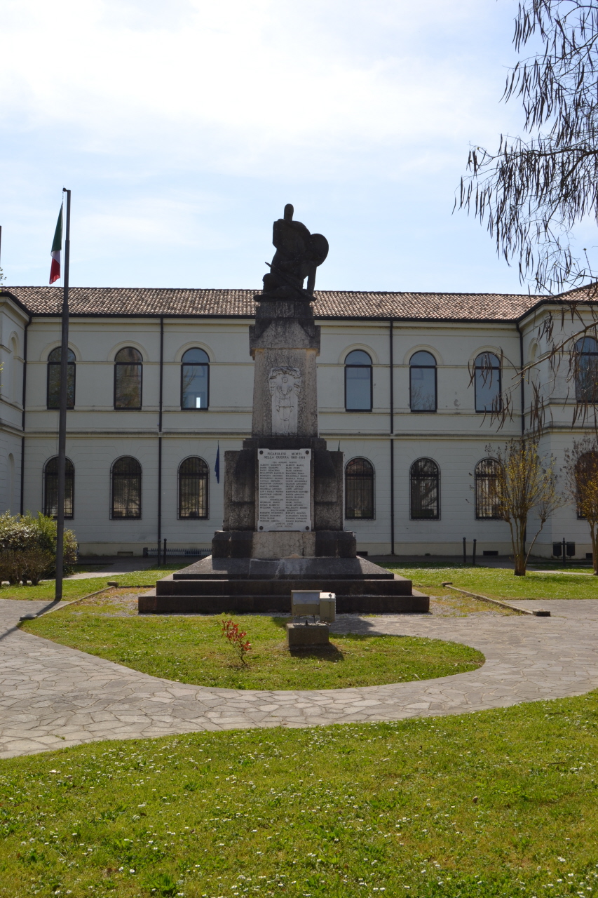 Allegoria della Patria come donna armata che protegge un soldato, Allegoria della morte del soldato (monumento ai caduti - a cippo) di Milani Virgilio (sec. XX, sec. XX)