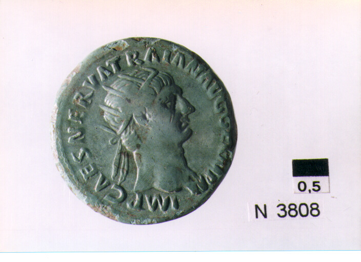 R/ testa radiata di Traiano a destra; V/ Abundantia siede a sinistra, su una sedia formata da due cornucopie, tenendo lo scettro (moneta, dupondio) (secc. I/ II d.C)