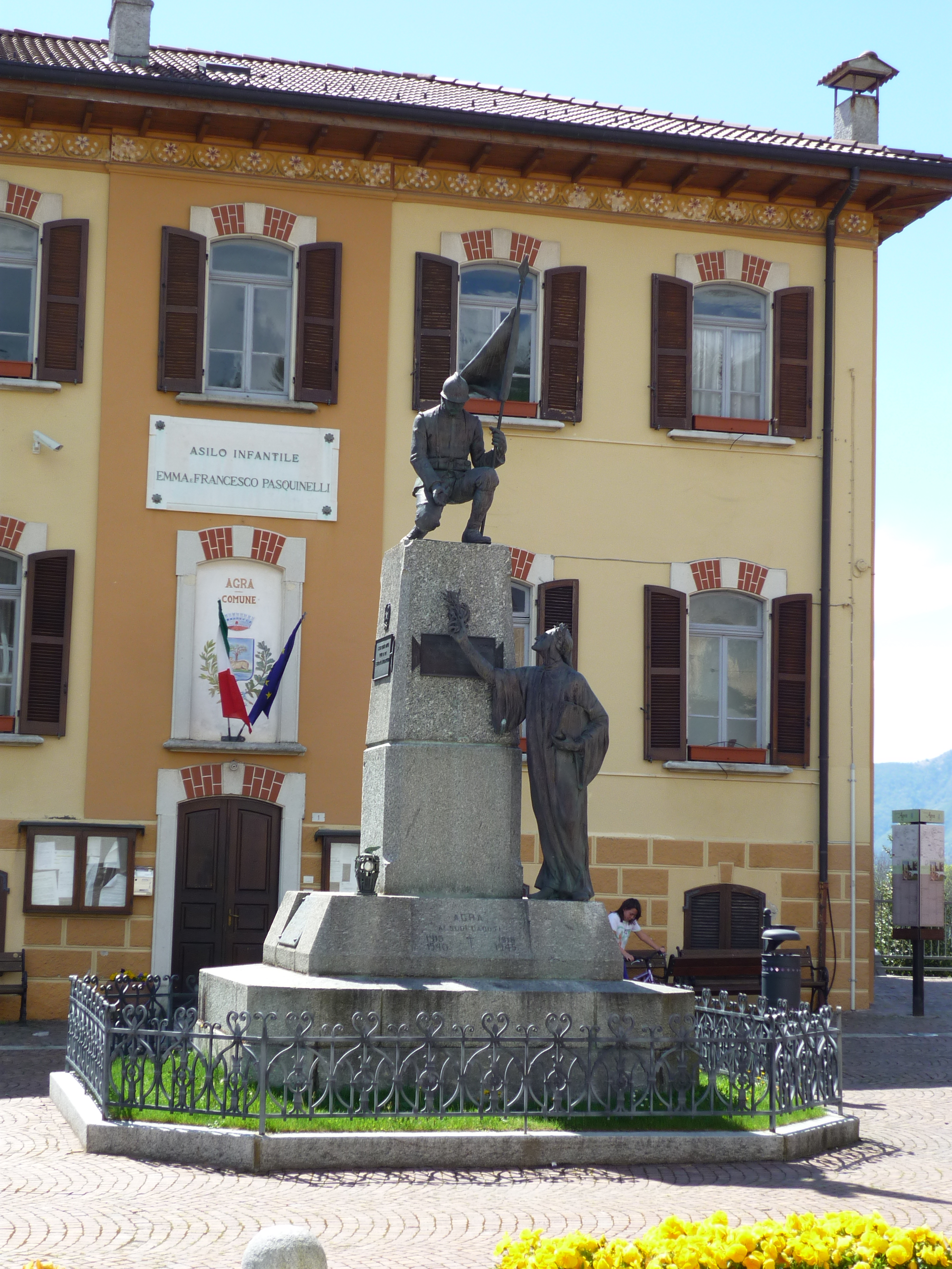 figura di soldato che porta la bandiera/ poeta Dante Alighieri (monumento ai caduti - a cippo, opera isolata) di Galletti Giorgio (sec. XX, sec. XX)