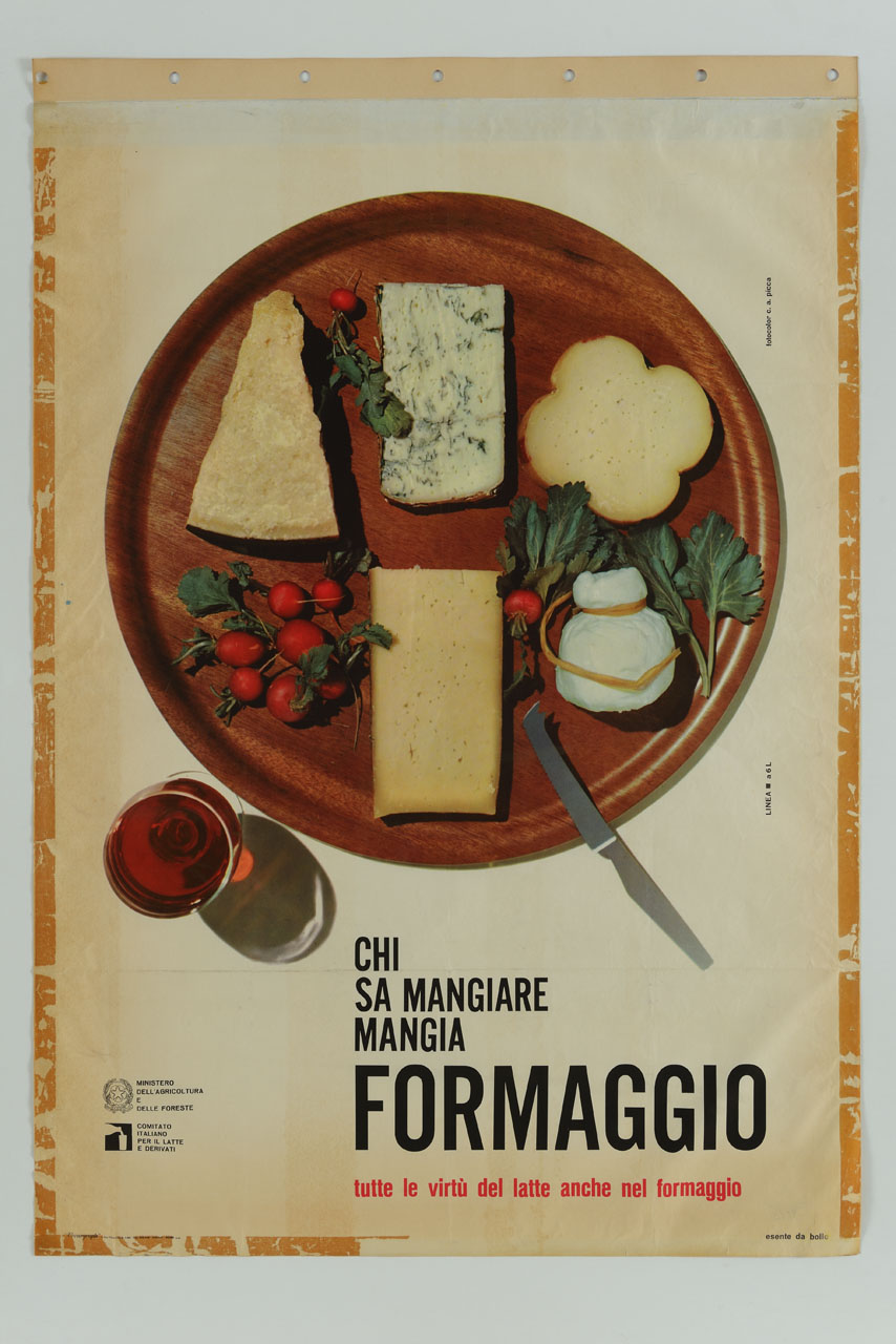 fotografia di un tagliere di legno, su cui è appoggiato un coltello e alcuni pezzi di formaggi e verdure; a fianco un bicchiere di vino rosso (manifesto) di Picca (sec. XX)