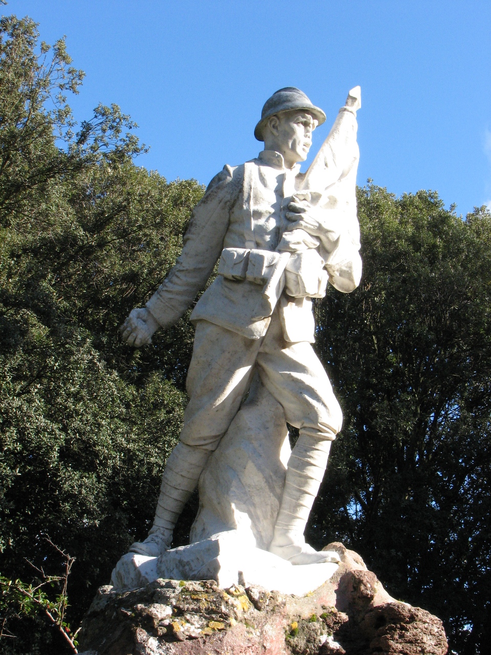 Figura di soldato in combattimento che porta la bandiera (monumento ai caduti - a cippo)