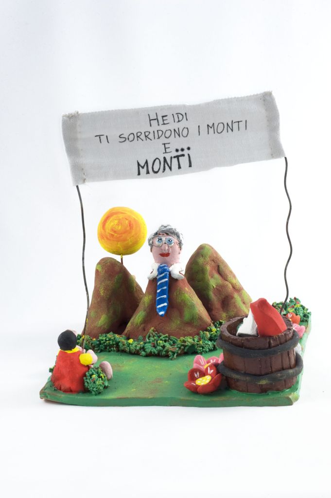 Heidi, ti sorridono i monti… e Monti, bambina seduta con uomo dietro montagne (fischietto, a fessura interna, strumenti musicali) di Iaffaldano Ilenia - scuola (2012)