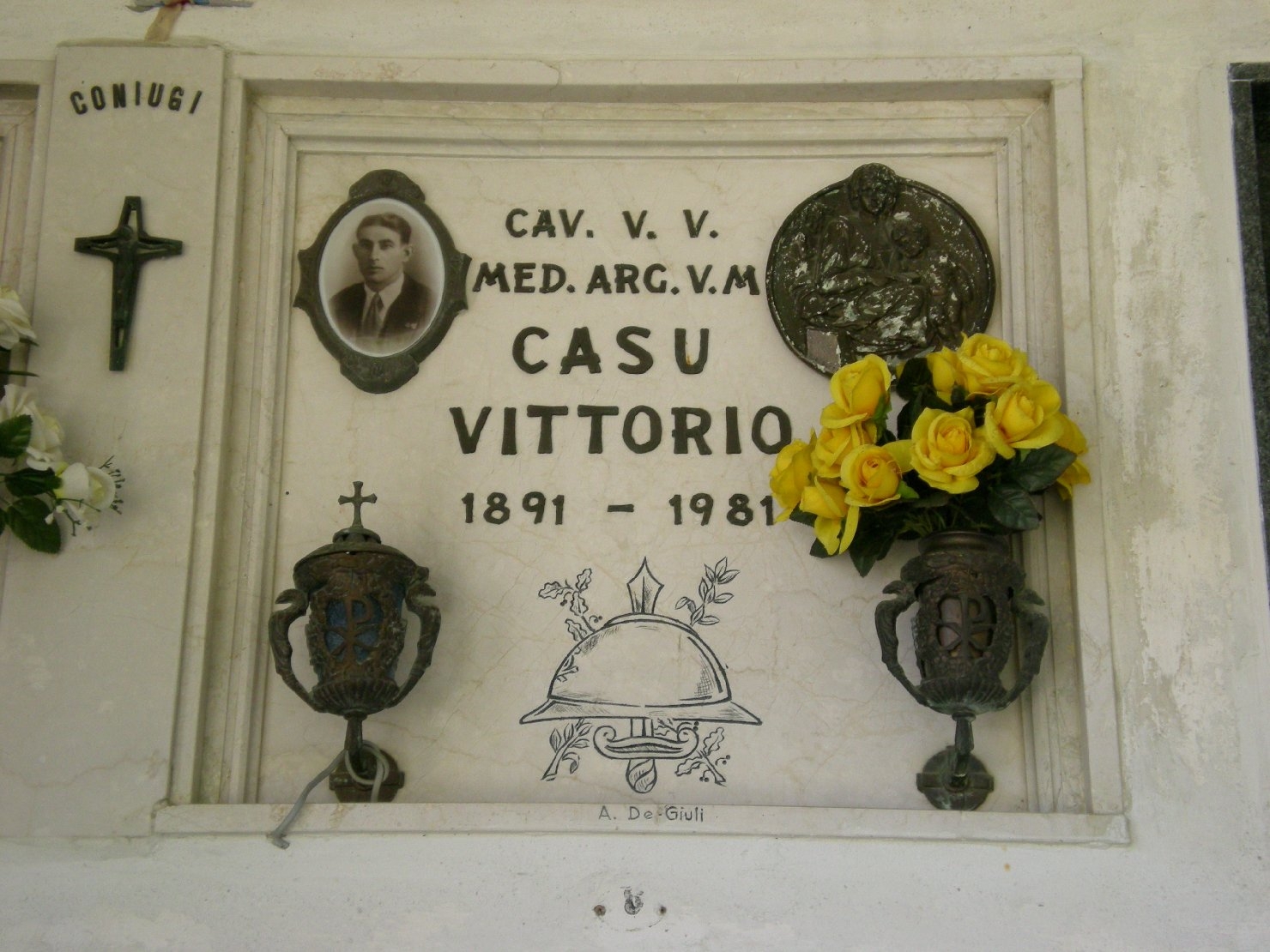 trofeo di armi con elmo, Madonna con Bambino (lapide tombale) di Ditta De Giuli (sec. XX)