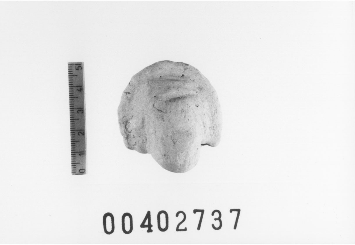 Figura femminile (Testa di statuetta, Comella, gruppo C I a 10) (III a.C, II a.C, I a.C)