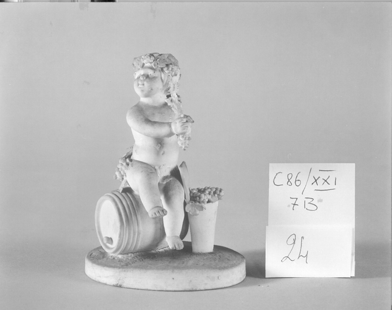 putto con botte e grappoli (statuetta, elemento d'insieme) - manifattura parigina (ultimo quarto sec. XVIII)