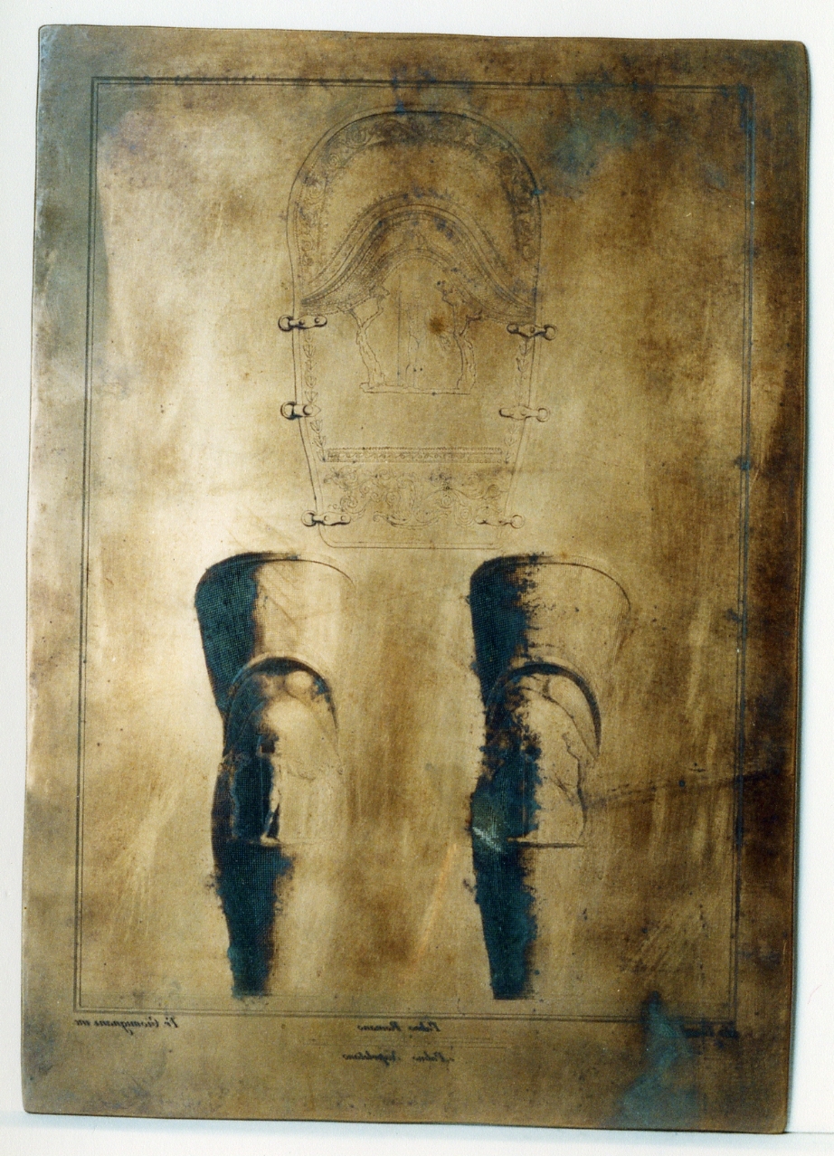 due parti di armatura in bronzo e particolare: schinieri (matrice) di Giomignani Francesco, Vanni Nicola (sec. XVIII)