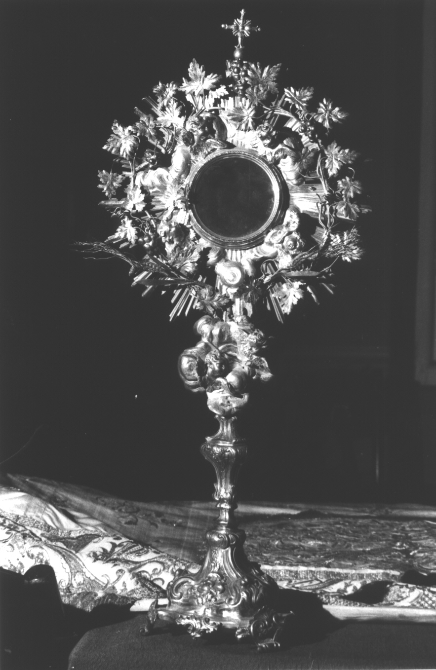 motivi decorativi zoomorfi/ motivi decorativi a volute/ teste di cherubino/ simboli eucaristici: spighe di grano e tralci d'uva (ostensorio - a raggiera, opera isolata) - bottega ligure (sec. XVIII)